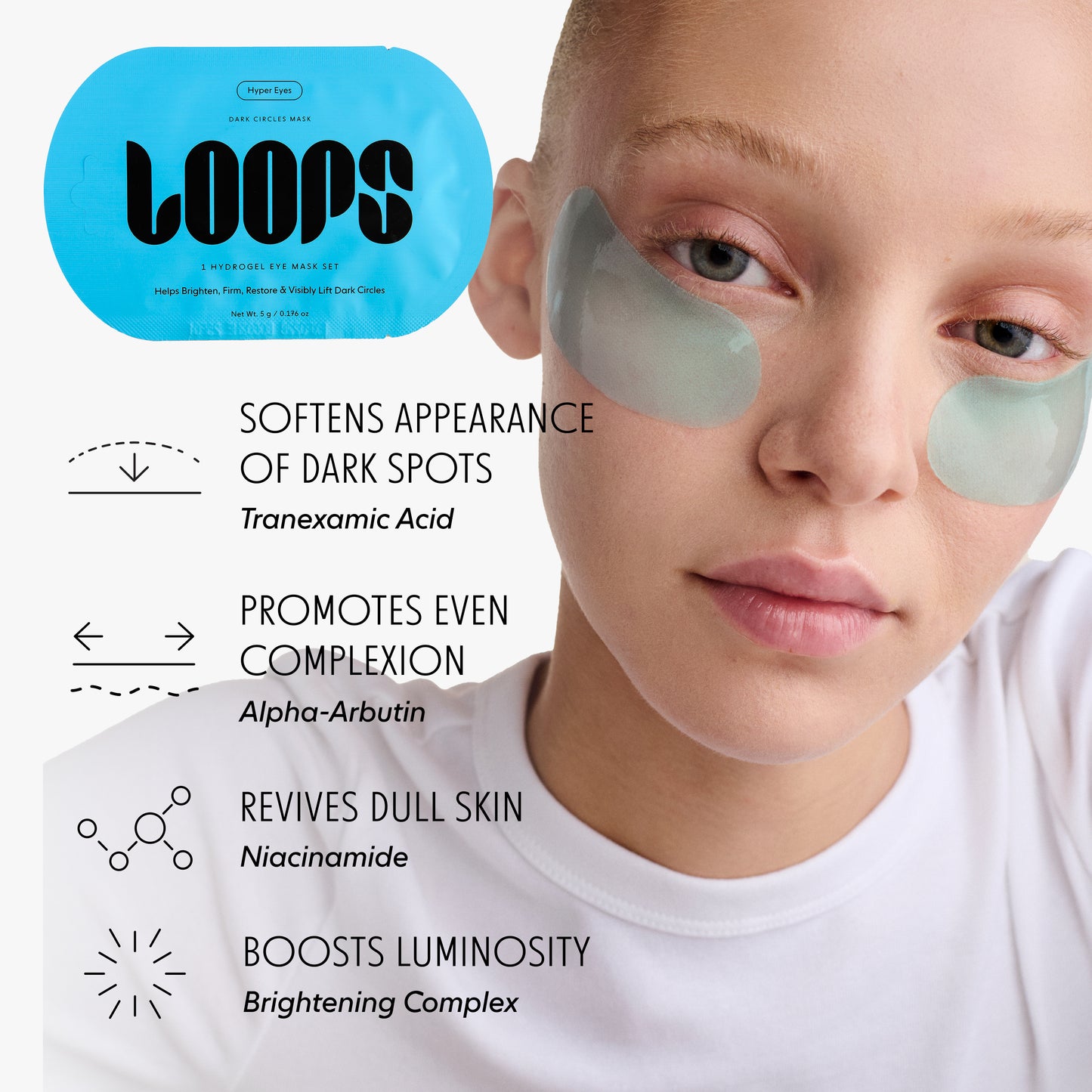 Person wearing under eye masks with 'LOOPS' branding and skin benefits listed. Softens Appearance Of Dark Spots (Tranexamic Acid); Promotes Even Complexion (Alpha-Arbutin); Revives Dull Skin (Niacinamide); Boosts Luminosity (Brightening Complex)