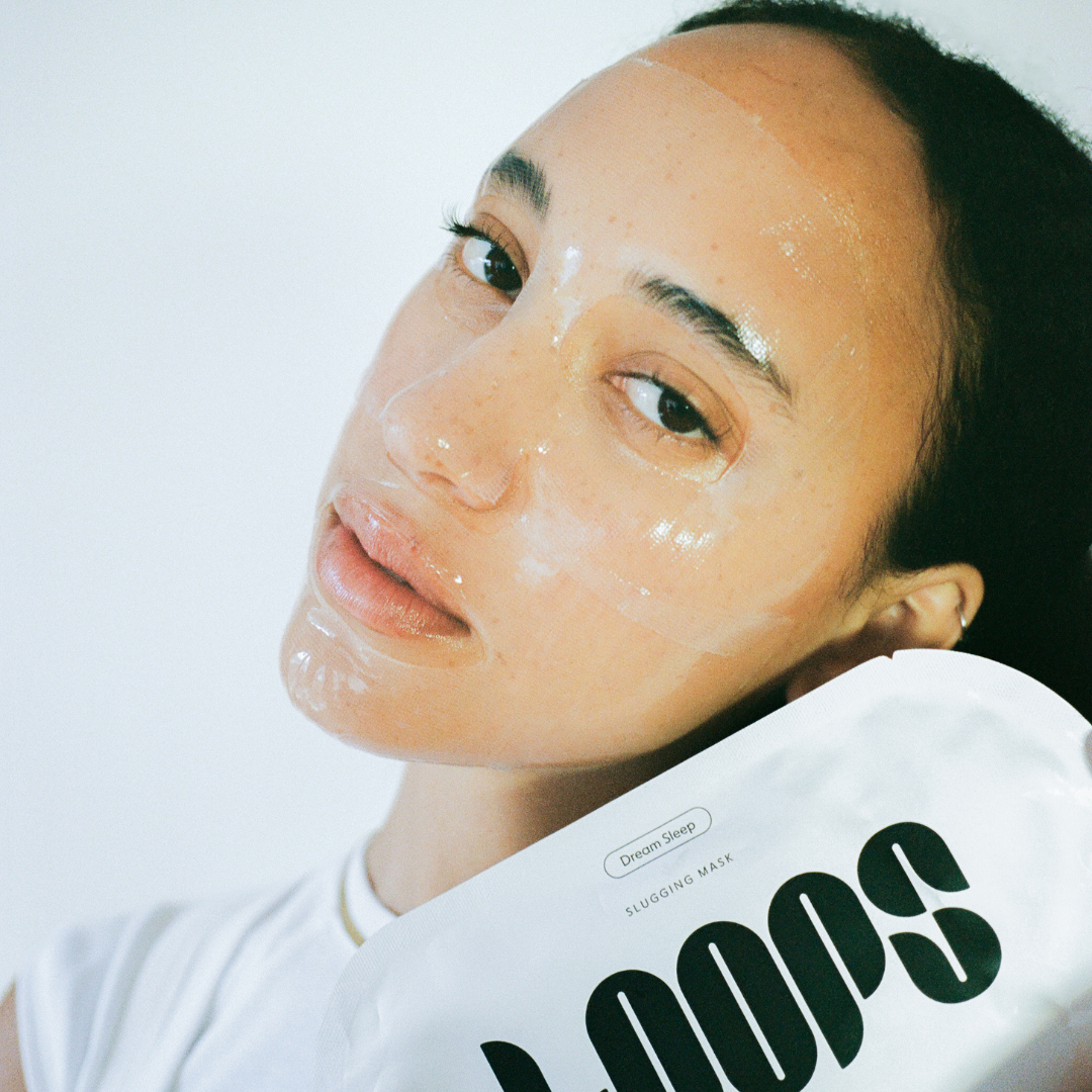 Woman wearing clear face mask holding package for dream sleep face mask