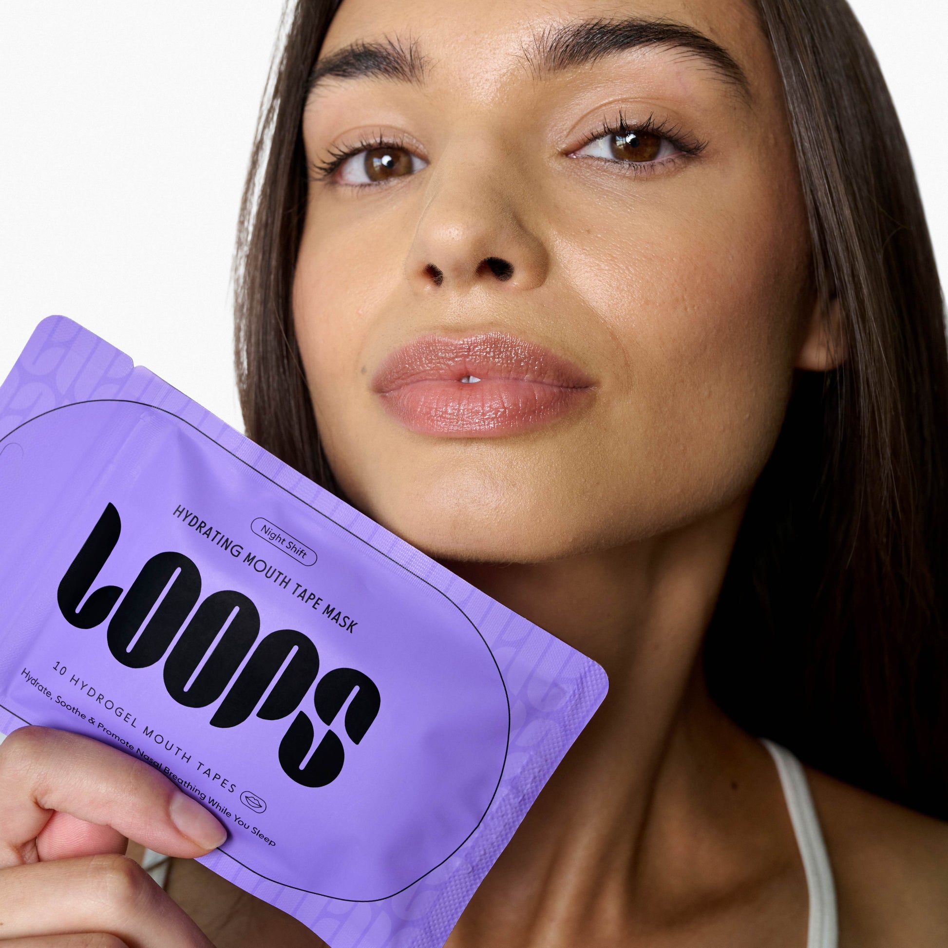 Woman holding a purple 'LOOPS' mouth tape mask packaging