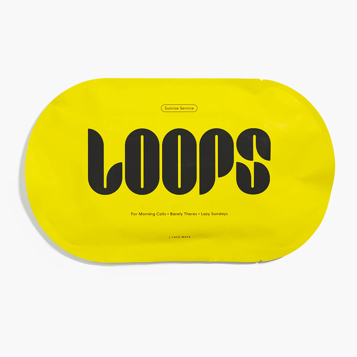 Oval shaped LOOPS Sunrise Service face mask in yellow packaging.