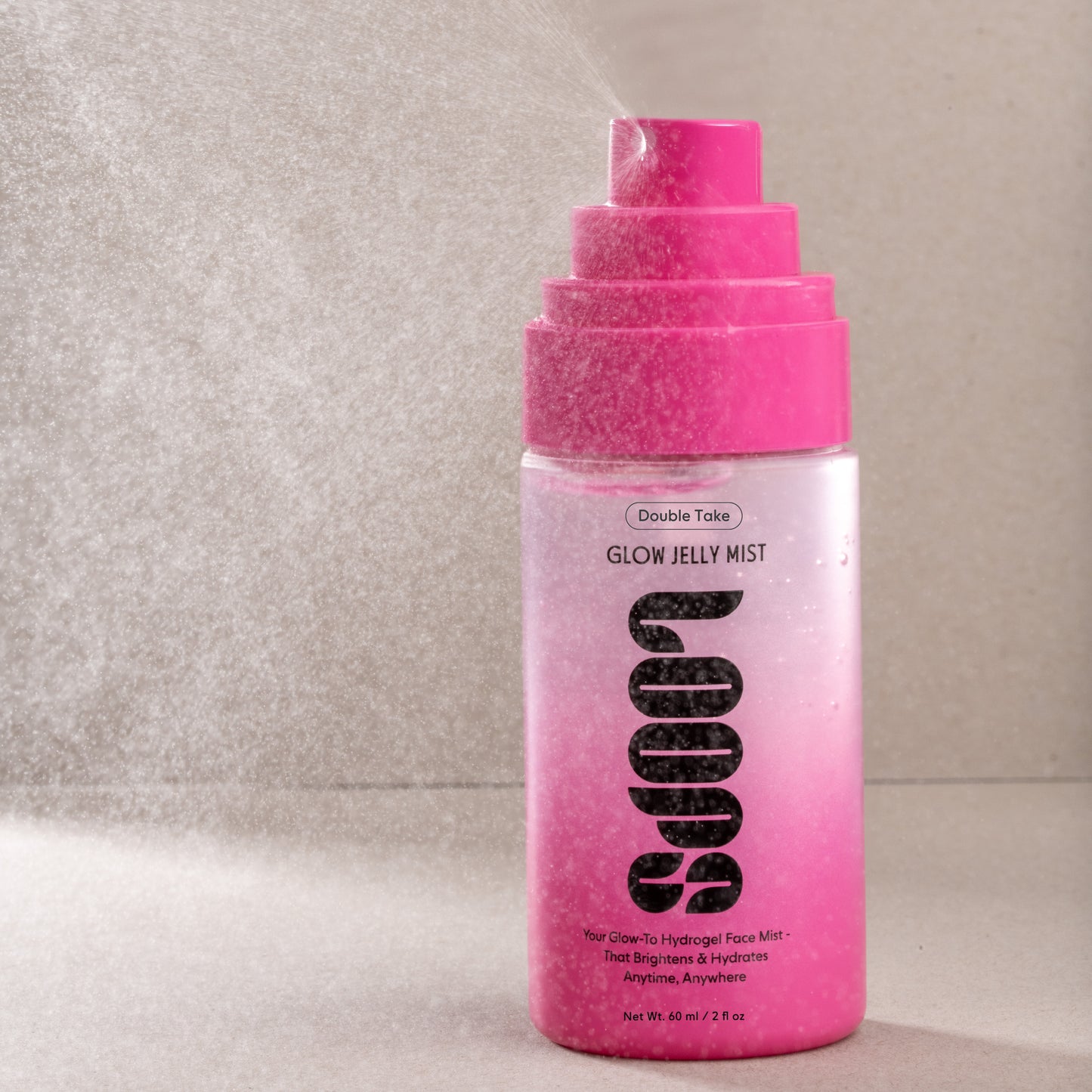 Pink and white bottle of Double Take Glow Jelly Mist on a neutral background