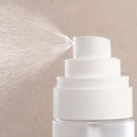 White top of dew cloud jelly mist with a beige textured background