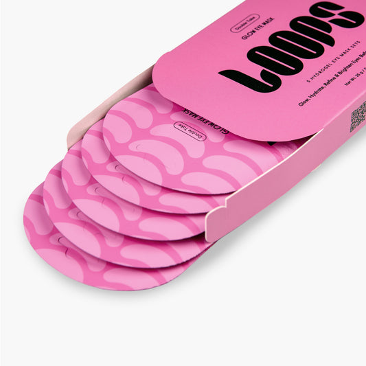 Pink packaging of LOOPS with multiple pink eye mask pouches inside on a white background