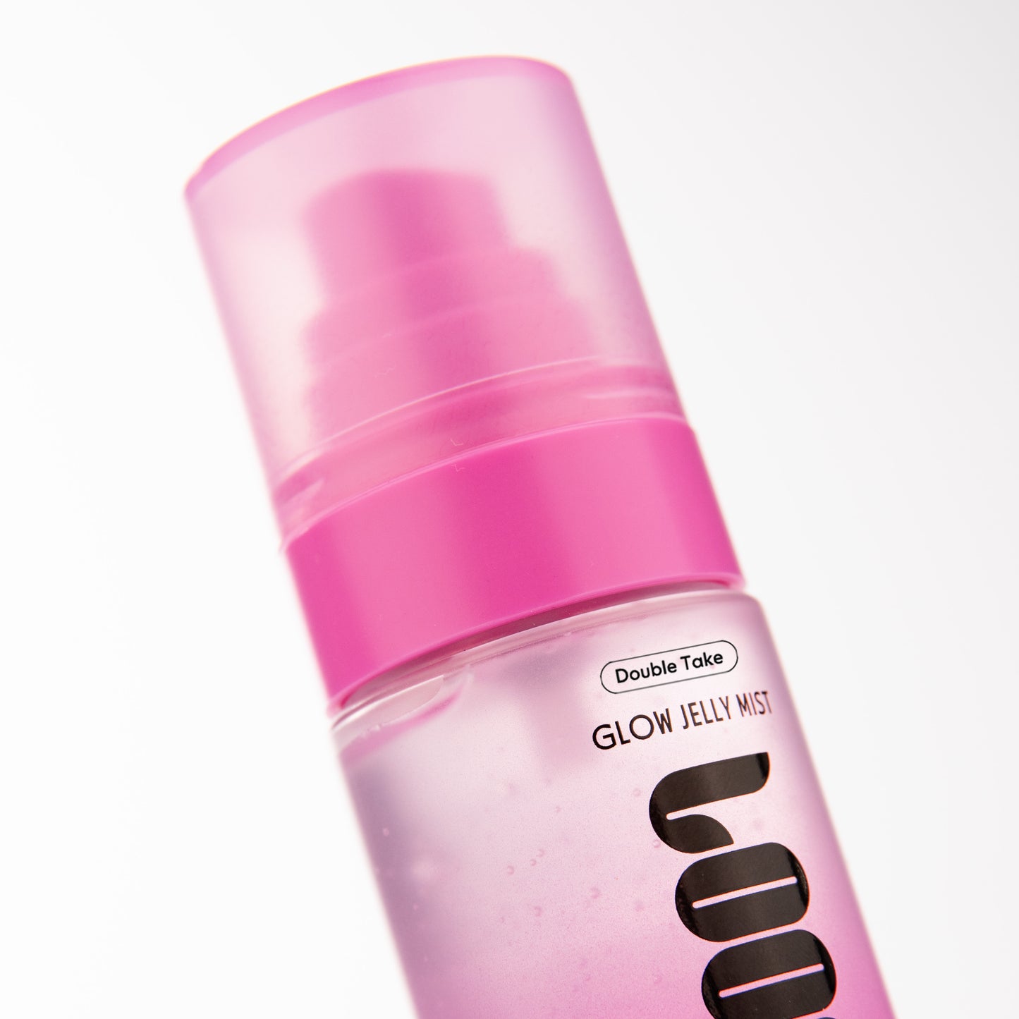 Pink spray bottle labeled 'Glow Jelly Mist' on a white background