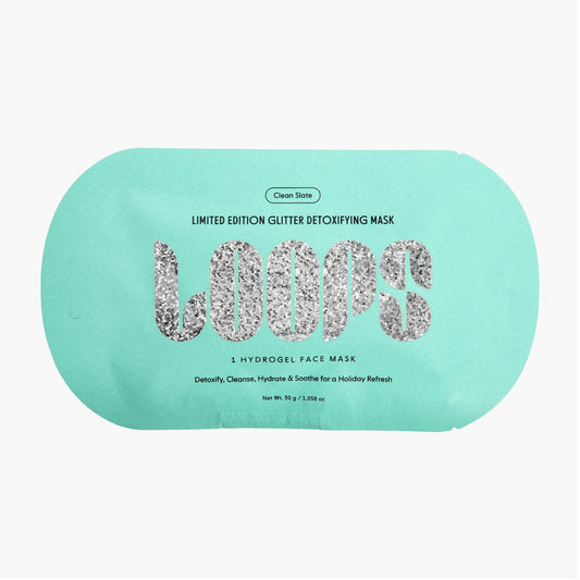 A mint green Clean Slate single-use face mask packet with 'LOOPS' written in glittery silver letters