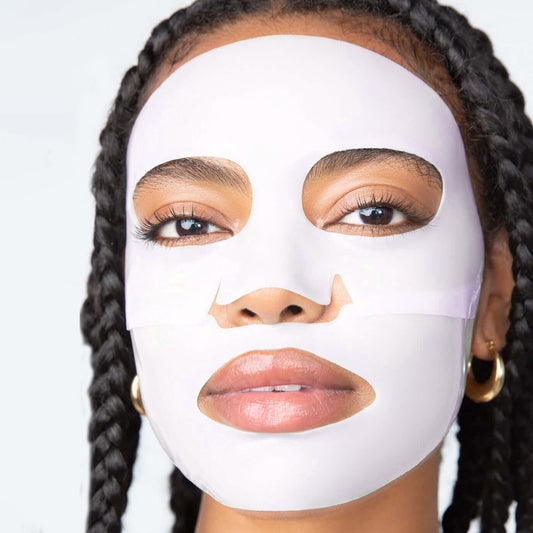 Female model facing forward with pinkish-white, 2-piece LOOPS Hydrogel face mask on.