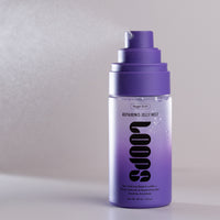 A bottle of Loops Night Shift Repairing Jelly Mist with a purple pump dispenser and a clear body showing a purple gradient liquid inside, set against a neutral gray background.