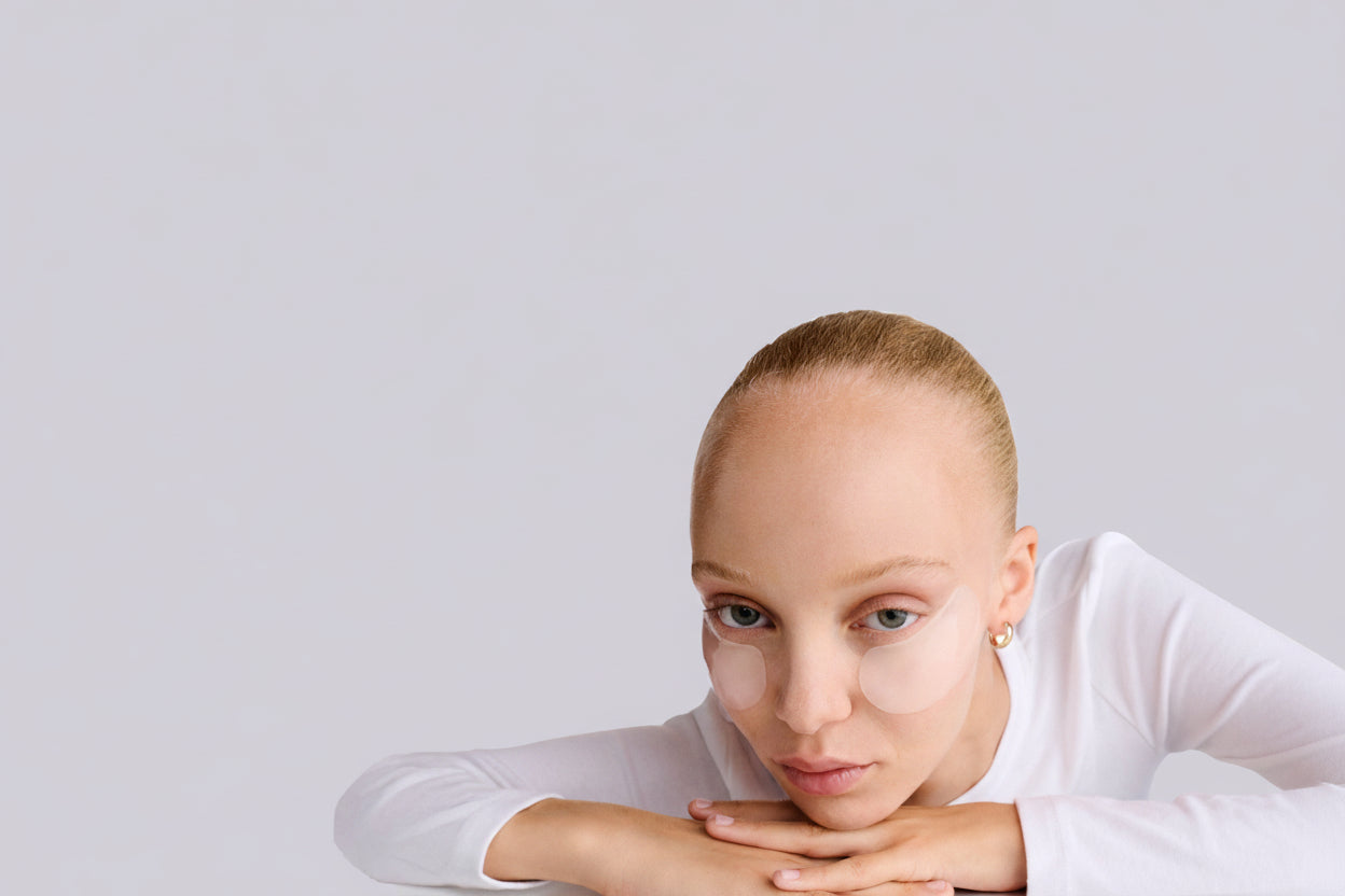 Person wearing a white shirt with text 'Masks for Moments. Skincare Designed for All.'