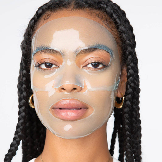 Female model facing forward with translucent, 2-piece LOOPS Hydrogel face mask on.