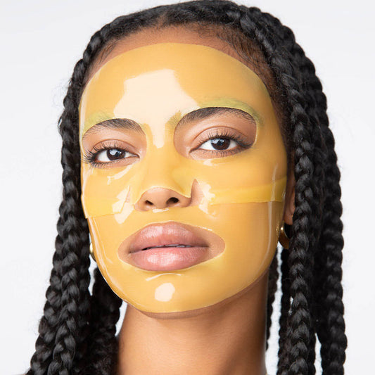 Female model facing forward with yellow, 2-piece LOOPS Hydrogel face mask on.
